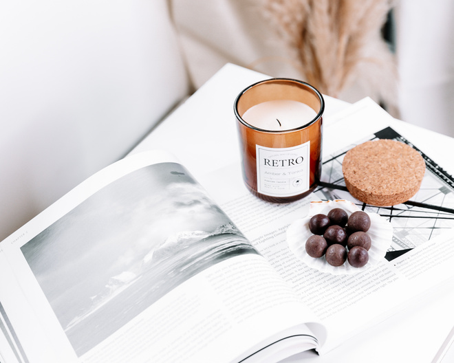 Candle with magazine and chocolate